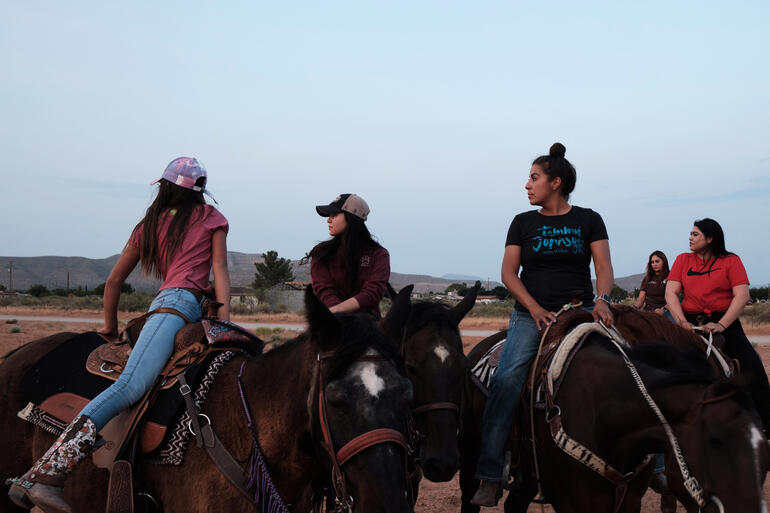 Patricia Quintanilla, third from right, and her class look on anxiously as a student fights to regain control of an uncooperative horse. El Paso, Texas. 2020.