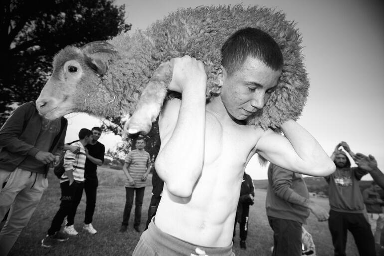 Andrei, the winner of Hirtop&#39;s Summer Games wrestling tournament, collects his prize. Moldova, 2023.